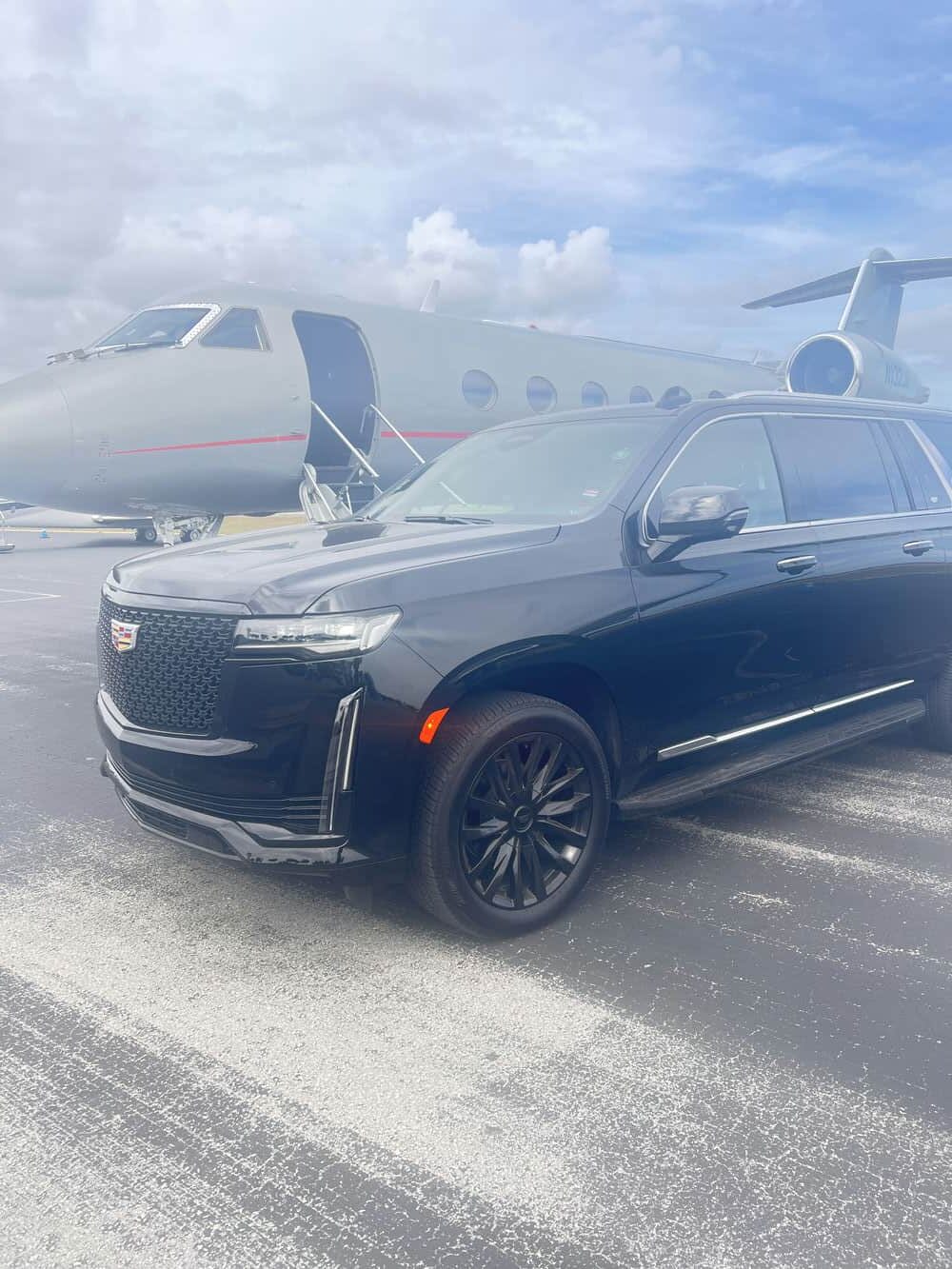 Miami Supreme Limo Cadillac Escalade waiting planeside for a private jet arrival