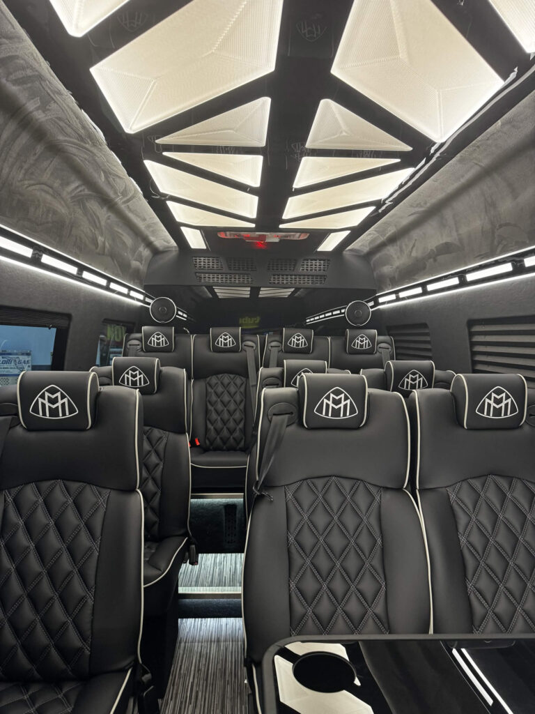Rows of quilted black leather seats inside the Mercedes-Benz Executive Sprinter