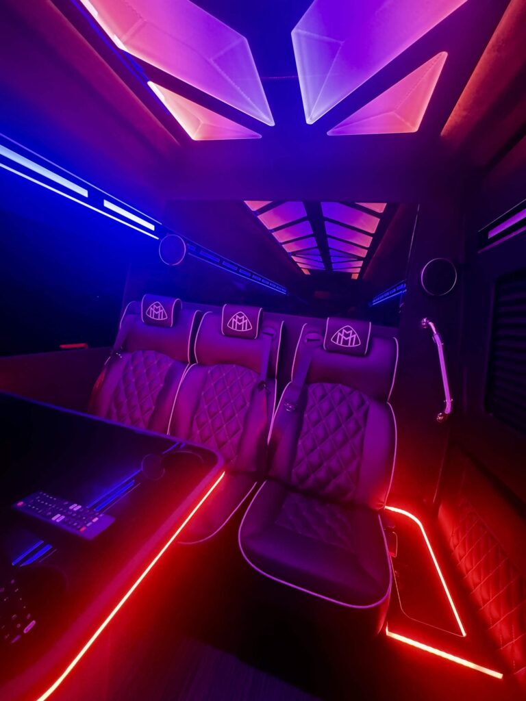 Mercedes-Maybach Sprinter captain's chairs with red and purple ambient lighting